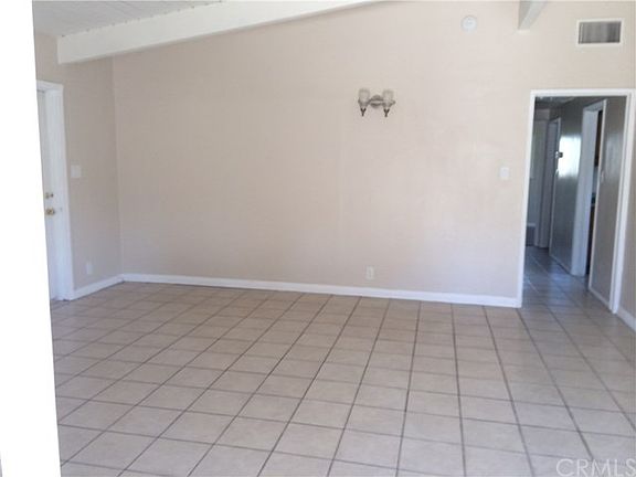 Spacious living room with cathedral ceiling and ceramic tile floor through out the house.