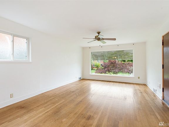 The Living Room with a huge bay window and beatuful hardwood floors! 