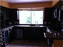 Updated U shape Kitchen; Kitchen window looks out to back yard.