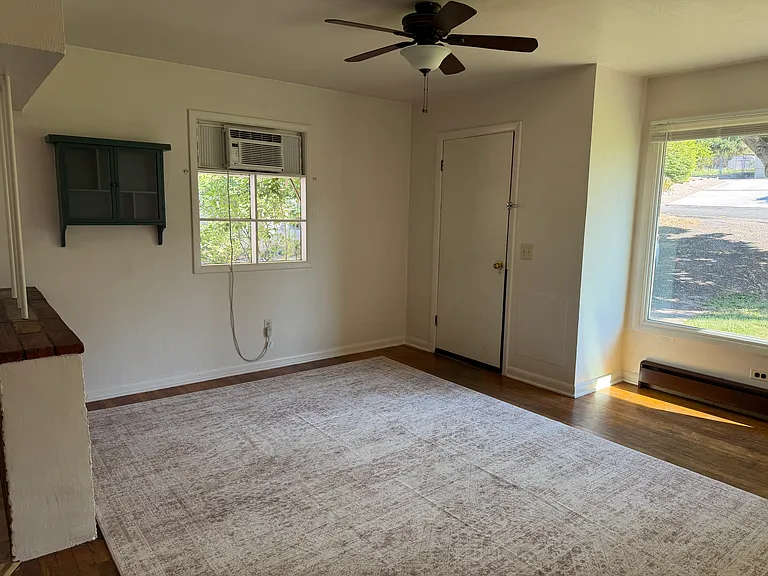 Living room with A/C and front door.