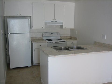 Kitchen w / New: Refrigerator, Stove & Dishwasher.