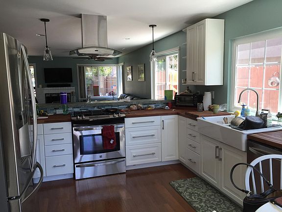 Open layout kitchen with large granite bar and farmhouse sink