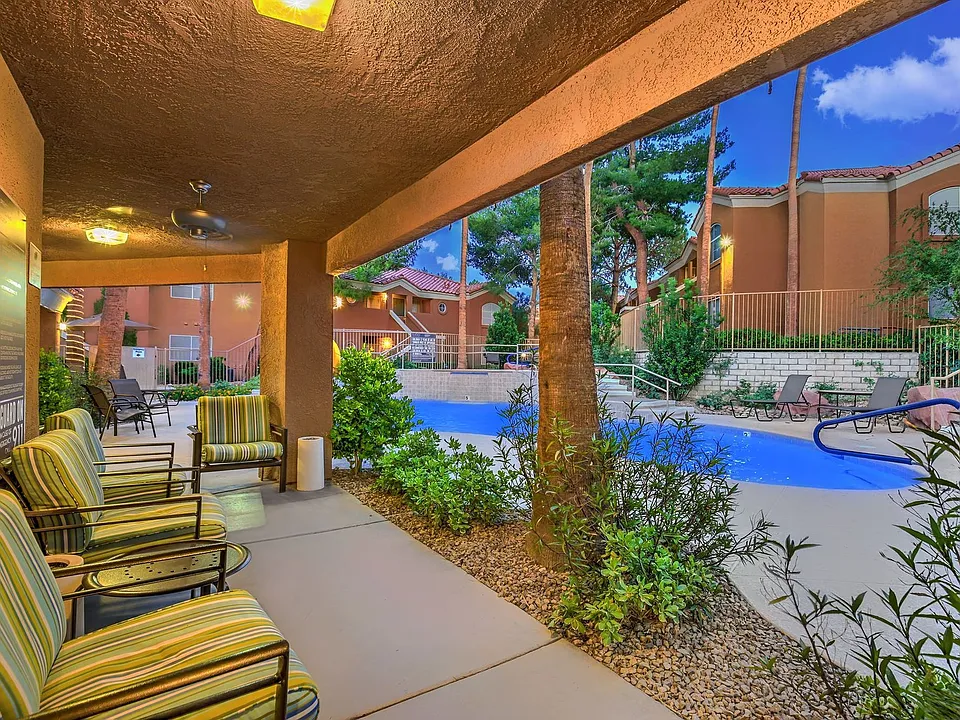 Poolside seating areas with cushions and lights.