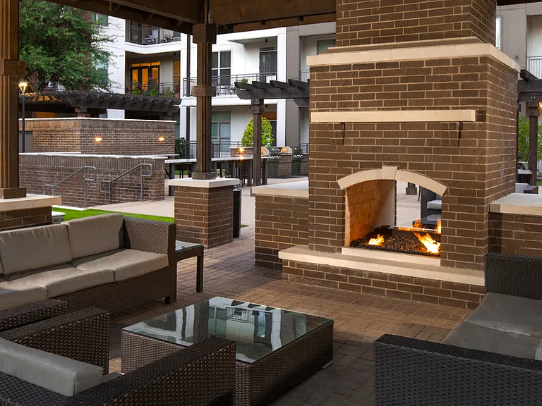 Outdoor cabana with fireplace and lounge