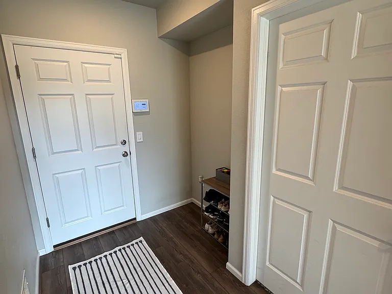 Corner section for shoes and storage. Leads into garage door.