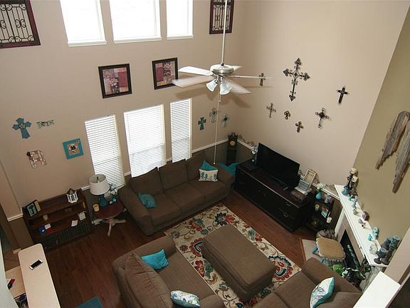 Two-story family room opens up the space in a dramatic way. Lots of natural light and a gas log fireplace for cooler weather.