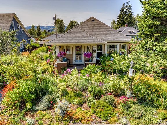 And just for good measure we want to show you how pretty the flowers look in the summer. There's a walkway just in front of the house and one on each side of the home to enjoy everything that's been planted.