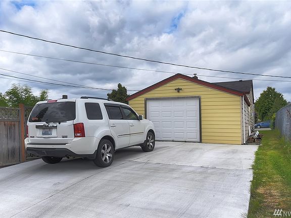 Detached one car garage plus 4 more parking spaces from this alley entrance. Gate behind car. Access the garage from the back deck of the home