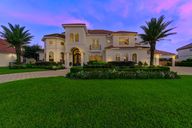 A stunning Kickerillo Signature estate greets you with commanding curb appeal on a rare 19,020 SF ravine lot. A sweeping circular driveway, manicured landscaping, and stately brick and stucco exterior set the tone for refined elegance and privacy with no rear neighbors.