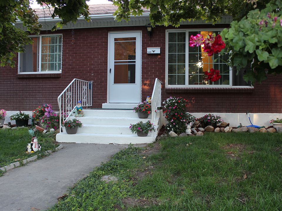 Trees frame the front entry