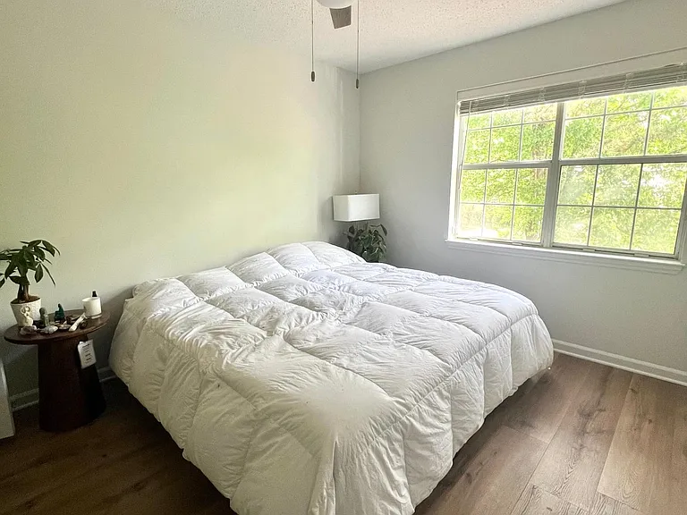 Bedroom with new floor, paint, fan and blinds