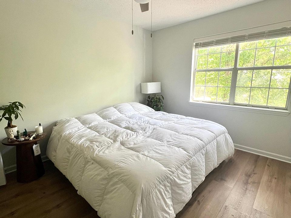 Bedroom with new floor, paint, fan and blinds