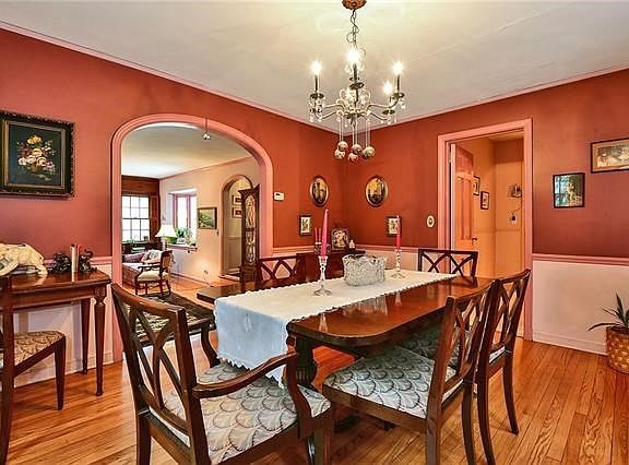 Dining Room with curved entrance to the Living Room and door to kitchen.  Note the beautiful hardwood floors.