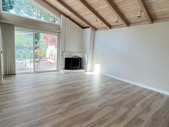 Beautiful vinyl plank flooring and custom cedar lined ceiling in the front living room is jaw-dropping!