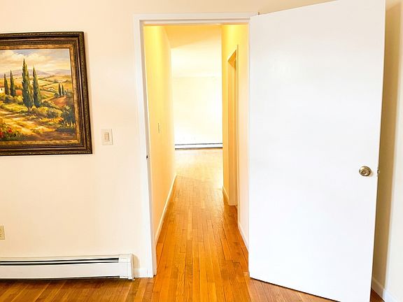 Hallway to bathroom and living room from the bedroom