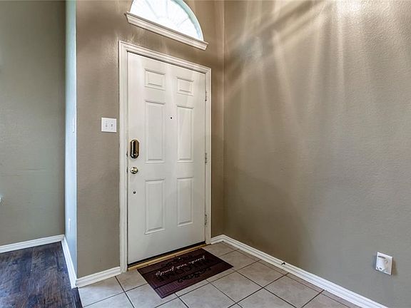 As you enter this lovely home, there is  ceramic tile at the entryway. Walk into  a combination formal living and dining room with a laminate wood floor.