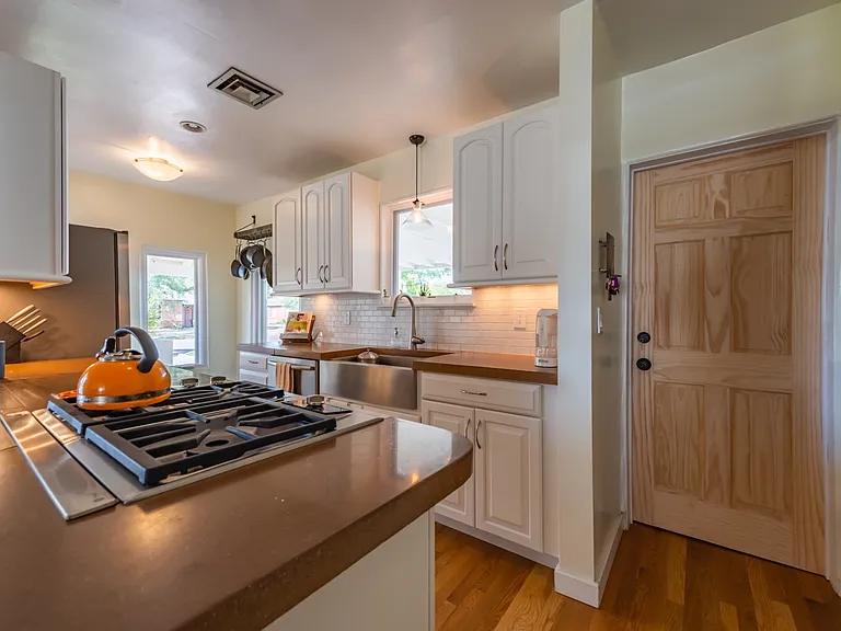 Kitchen and door to separate apartment (not included)