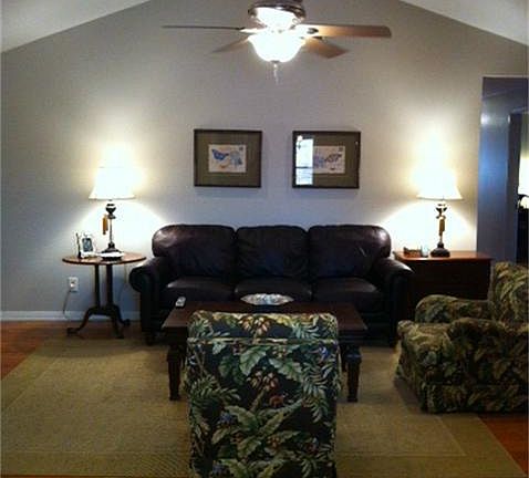 Vaulted ceiling in family room with recessed lighting, hardwood floors and custom built-in cabinet.