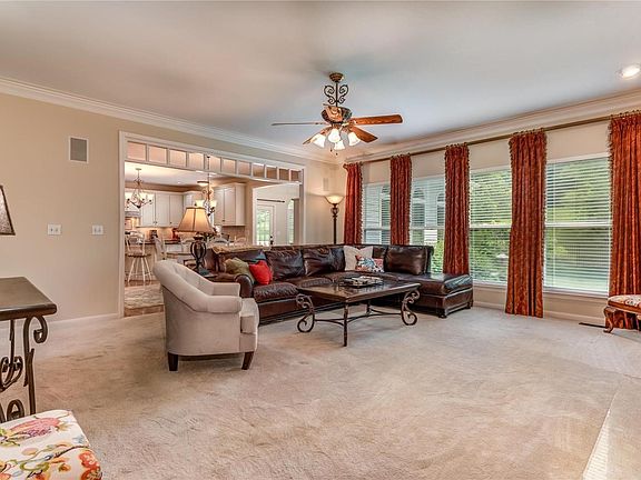 Wonderful open great room that opens to kitchen/breakfast room and hearth room has a wall of windows overlooking the private backyard