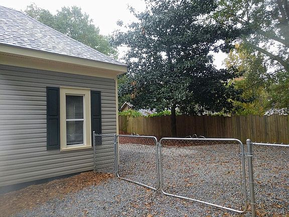 Drive through gate into back yard. Fully fenced yard to keep children and dogs safe within the park like setting back yard.
