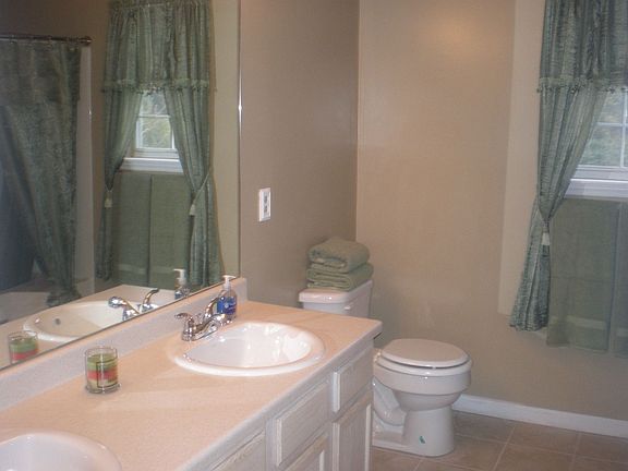 Updated Master Bath has new tile, new countertop, new sinks & upraded fixtures
