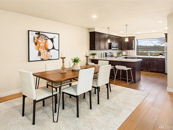 Inviting dining area opens onto remodeled kitchen, living area and view deck.