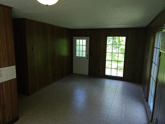 Living area from kitchen. Door opens to front.