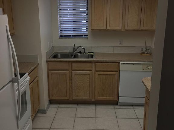Kitchen looking at sink and diswasher.