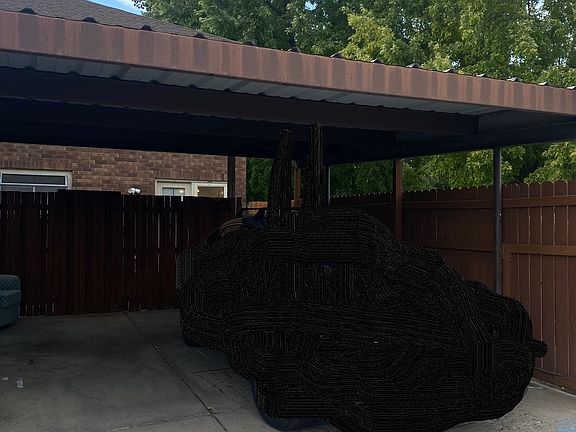 Double carport and back entrance/patio.