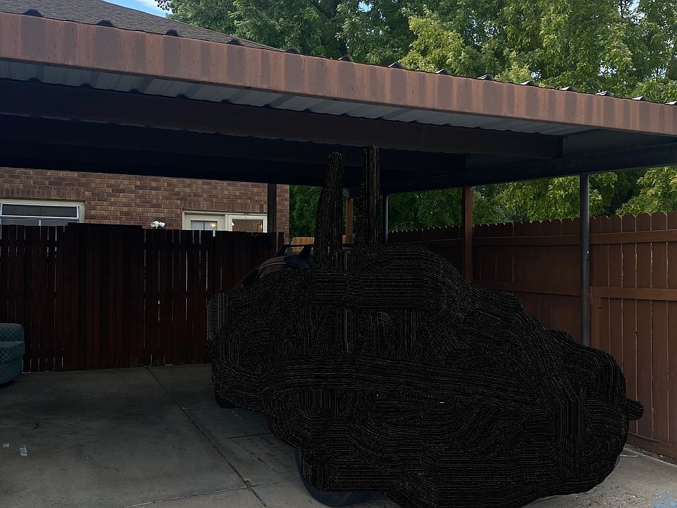 Double carport and back entrance/patio.