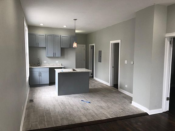 Open Kitchen/Dining space. Kitchen includes: dishwasher, gas oven, & large refrigerator. Washer & Dryer located just to the right of the kitchen. Second bedroom next to that