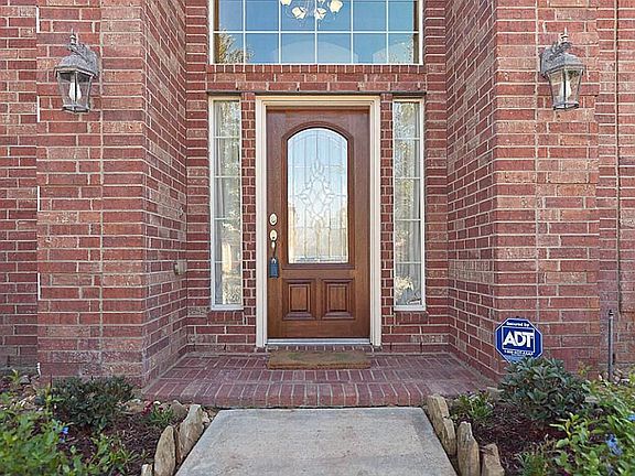 Brick porch pavers. Mahogany front door with leaded glass