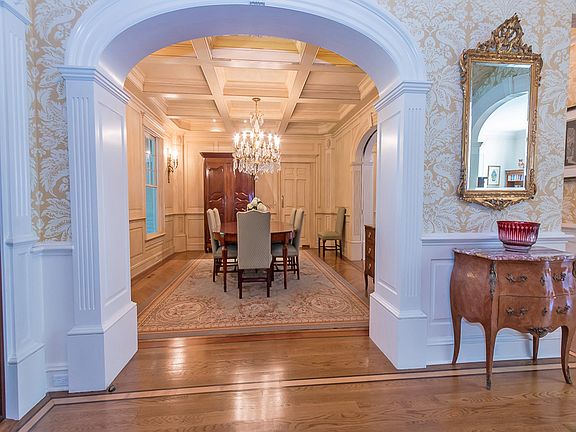 View from the entrance hall into the dining room showcasing the stunning millwork