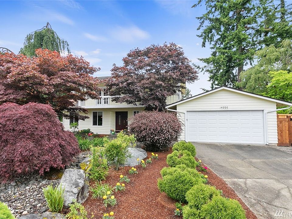 Welcome home to Fairwood Greens. This spacious 4 bedroom, 3 bath home offers great curb appeal and lush landscaping. You'll discover a wonderful gathering place in the chef's kitchen featuring countless upgrades and an expansive view of the backyard. This space is perfect for entertaining with open sight lines to the informal dining area and walls of windows to the lovely backyard and covered deck offering year-round enjoyment. Delight in the spacious living room, dining room and family room. Also on the main floor, you'll appreciate having a large bedroom adjacent to a remodeled full bathroom--a perfect guest suite or home office. The lovely master bedroom features an enviable walk-in closet and a gorgeous updated ensuite bath with soaking tub, dual vanities and a door to a secluded deck that runs the length of the front of the home and is nestled in the trees. 