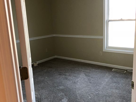 Full bedroom with window to backyard and en suite full bathroom