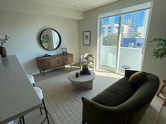 Modern 1-bedroom at The Boutique offering a sun-filled living area, contemporary design, and private balcony creating a seamless indoor-outdoor lifestyle.