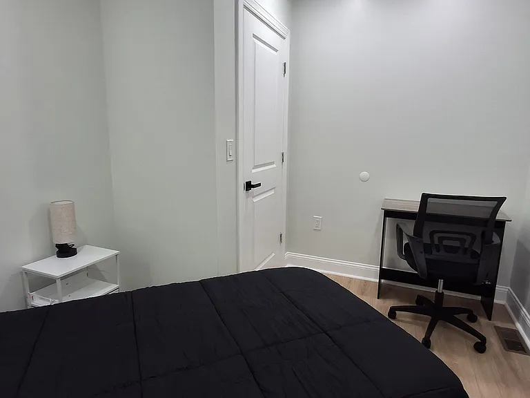 Private bedroom featuring light-toned flooring, a closet, and a dedicated desk area for working or studying.