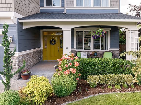 Enjoy a fresh cup of morning coffee on your charming spacious covered front porch.