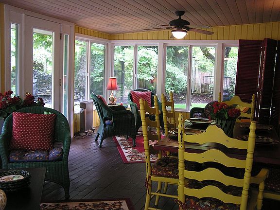 Fantastic sunroom, brick floor, ceiling fan, french doors