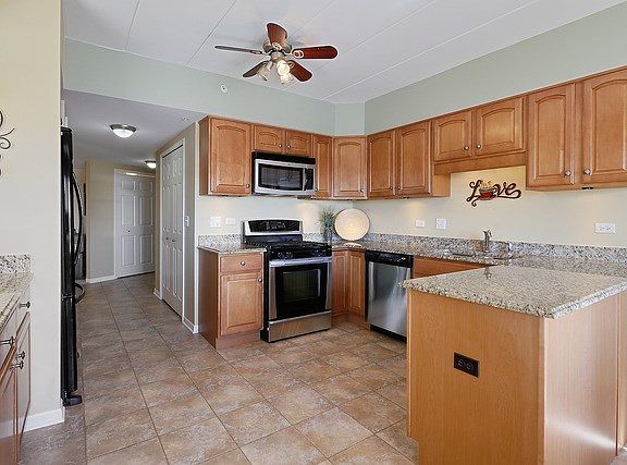 Lovely maple cabinetry, sleek granite counters, ceramic tile flooring.