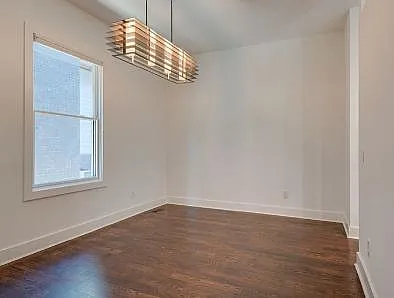This dining room is located just behind the wall where the stove is.