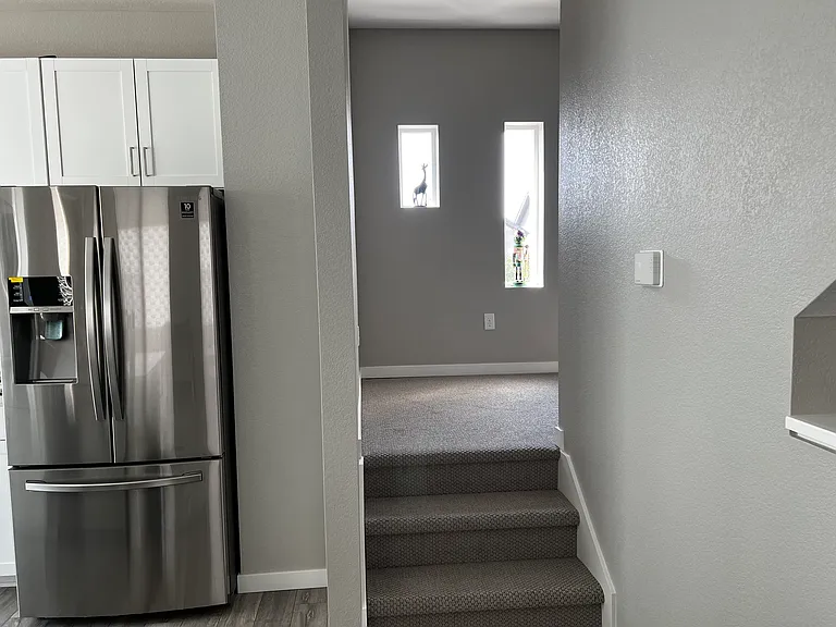 Stairs leading to 3rd floor with ample light.