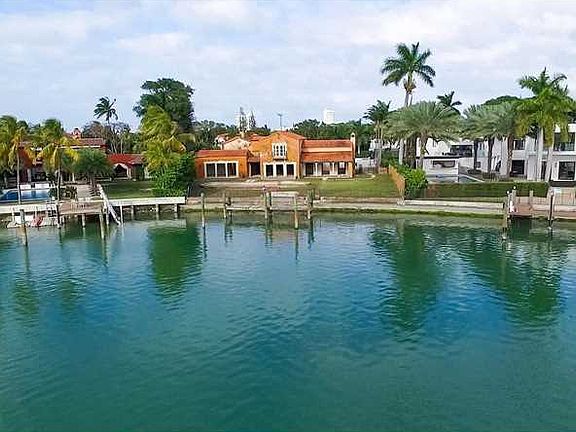 Great opportunity to own an incredible pie-shaped waterfront Mediterranean estate on Lower North Bay