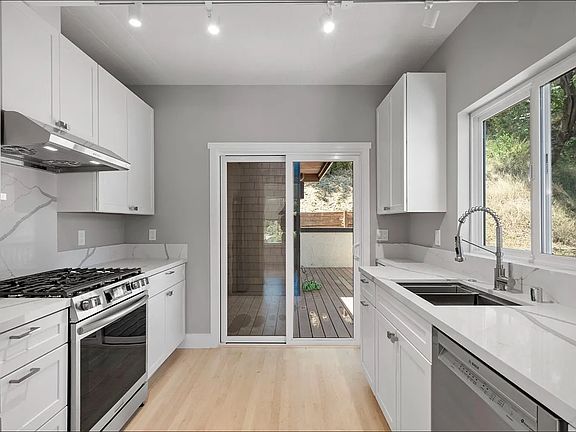 Brand new kitchen with quartz countertops, stainless steel appliances and Bosch dishwasher. Door to new deck. Abundant natural light. Brand new kitchen cabinets with soft close doors.