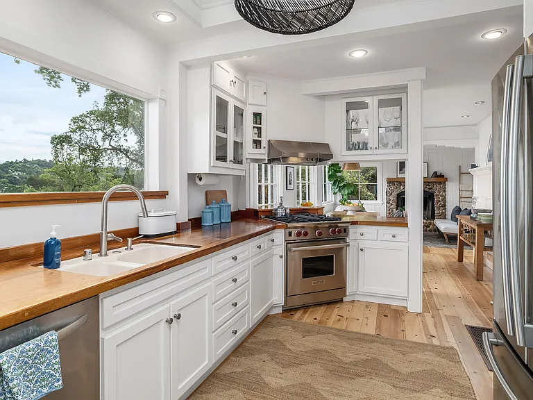 Kitchen view featuring mahogany countertops and viking range.