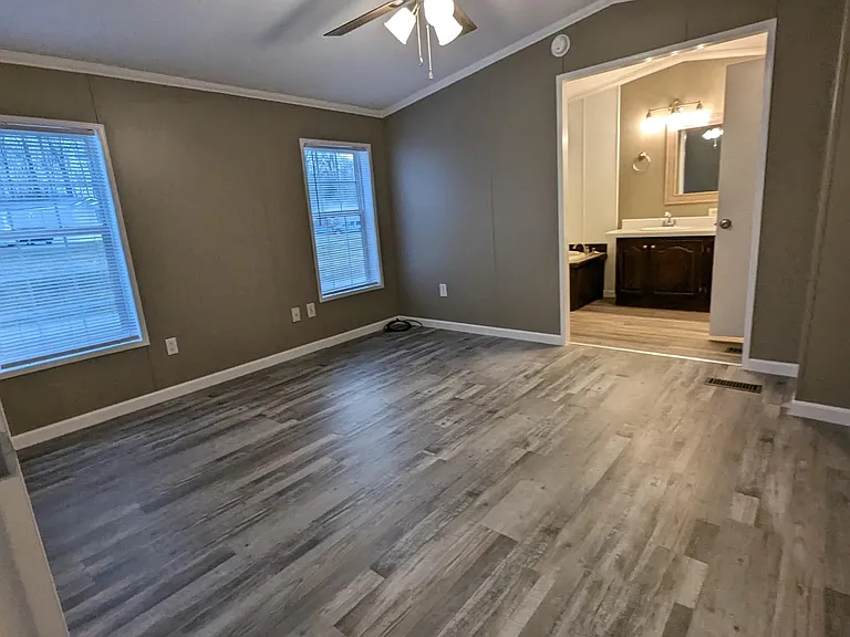 Bedroom 3 (master) with ensuite bathroom, two windows, ceiling fan, and double his/her closets