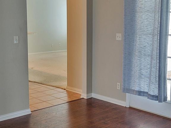 A different view of the living/dining room that leads into the kitchen/family area.