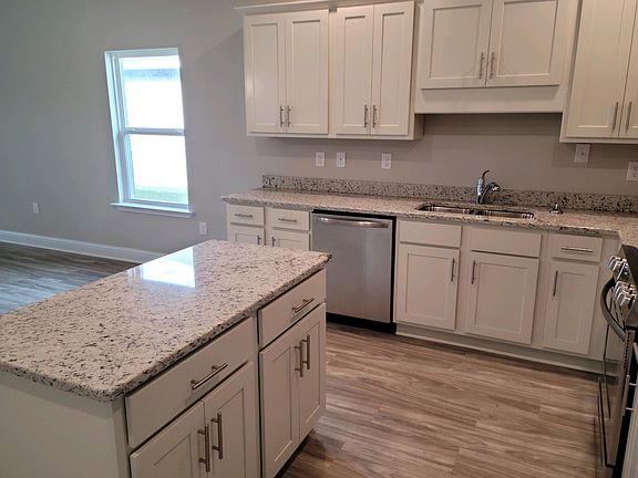 Kitchen with granite counter tops and island