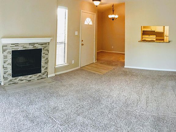 Living room with dining area in rear.