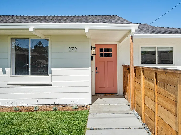 Private front entrance with charming custom coral front door